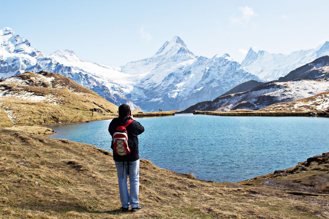 Snow-capped Swiss Alps reflected in an alpine lake near Grindelwald